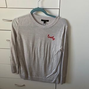 Plain grey long sleeve with “Lovely” in corner